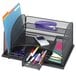 A black wire mesh Safco desk organizer with stationery in the compartments.