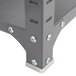 A close-up of a dark gray Safco commercial steel shelf with screws and bolts on it.
