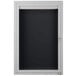 A white cabinet with a black framed door with a black letter board inside.