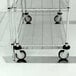 Metro aluminum floor pad protectors on a metal shelf with wheels.