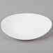 A white oval melamine platter with a textured rim.