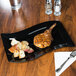 a piece of meat on a black plate