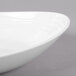 A close-up of a GET Magnolia ivory melamine bowl with a textured rim.