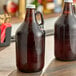 Two Libbey amber glass growlers on a table.