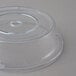 A clear plastic Cambro plate cover with a circular hole.