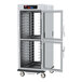 A Metro C5 heated holding and proofing cabinet with clear Dutch doors and wheels.