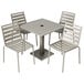 A BFM Seating South Beach square outdoor table with a metal base and square top surrounded by 4 chairs with metal legs.