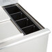 An Eagle Group underbar ice bin filled with ice on a counter.