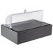 A black Vollrath food display platter with clear lid on a counter.