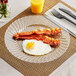 A WNA Comet clear plastic plate with bacon and eggs on it.