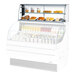 A white dry display case addon with glass shelves for showcasing baked goods and snacks.