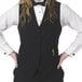 A woman in a black Henry Segal server vest and bow tie.