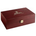 A Bromley wooden tea chest with a gold logo.