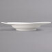 A close up of a Villeroy & Boch NewWave white porcelain deep plate with a curved edge.