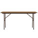 A medium oak rectangular folding table with a metal frame.