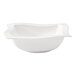 A Villeroy & Boch white porcelain salad bowl with a wavy edge.