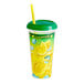 A 32 oz. clear plastic souvenir cup with a straw and lid filled with lemonade.