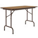 A brown folding table with metal legs.