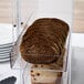 A clear plastic drawer with sliced bread in it.