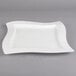 A white Villeroy & Boch square porcelain plate with a curved edge.