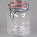 A clear glass jar with a metal lid and a metal clip.