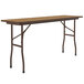 A brown rectangular Correll folding table with black legs.