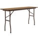 A brown rectangular Correll folding table with metal legs.