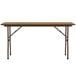 A Correll medium oak rectangular folding table with metal legs.