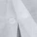 A close up of a white lab coat with buttons.