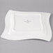A Villeroy & Boch white square porcelain plate with a design on it.