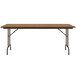 A brown rectangular Correll folding table with metal legs.