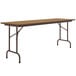 A brown rectangular Correll folding table with metal legs.