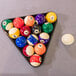 A triangle of pool balls with the Mizerak Dakota pool table in the background.