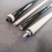 A black and white pool cue with a white tip.