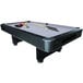 A Mizerak Dakota pool table with balls and cues on it.