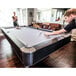 A man playing pool on a Mizerak Dakota pool table.