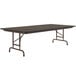 A Correll walnut rectangular folding table with a metal frame.