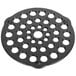 A circular black metal Lodge trivet with holes.