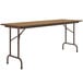 A brown rectangular Correll folding table with metal legs.