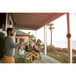 A group of people playing Viva Sol hook and ring game on an outdoor patio.