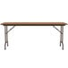 A Correll medium oak rectangular folding table with metal legs.