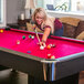 A woman playing pool on a Mizerak Donovan II pool table.