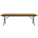 A rectangular Correll medium oak folding table with metal legs.