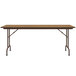 A Correll medium oak rectangular folding table with metal legs.