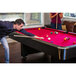 A man playing pool on a Mizerak Donovan II pool table.