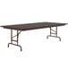 A Correll walnut rectangular folding table with a metal frame.