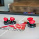 An Atomic air hockey table with red knobs on the sides.