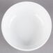 A Libbey Alpine White Porcelain Nappie bowl on a gray surface.