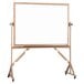 A white board on a stand with a wooden frame.