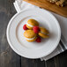 A Libbey alpine white porcelain plate topped with chocolate and raspberry cookies.